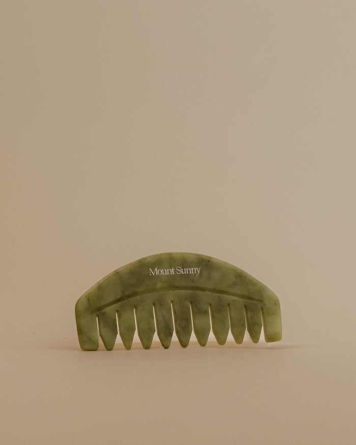 Green comb with 'Mount Sunny' branding on a beige background